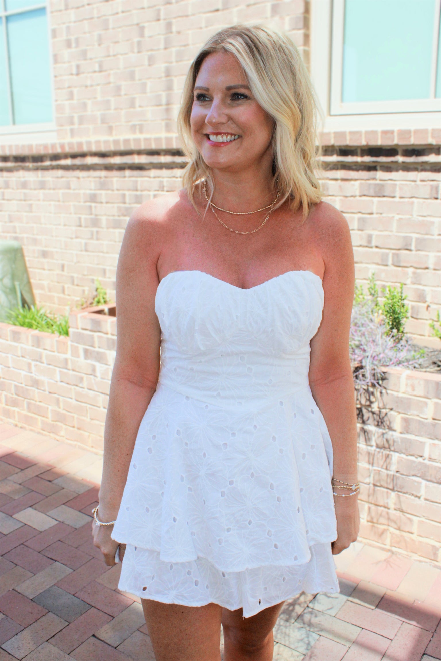She Can and She Will Strapless Tiered Cotton Eyelet Romper in White